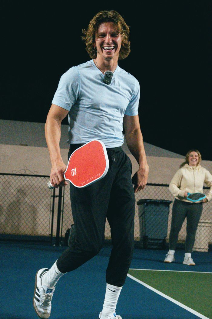 services-03 Adults enjoying a lively pickleball game at night in Scottsdale, Arizona.